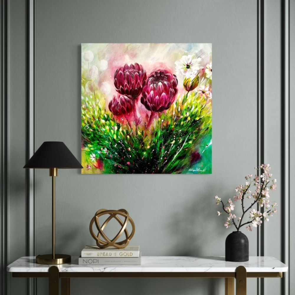Framed floral painting on a wall above a table with decorative items.