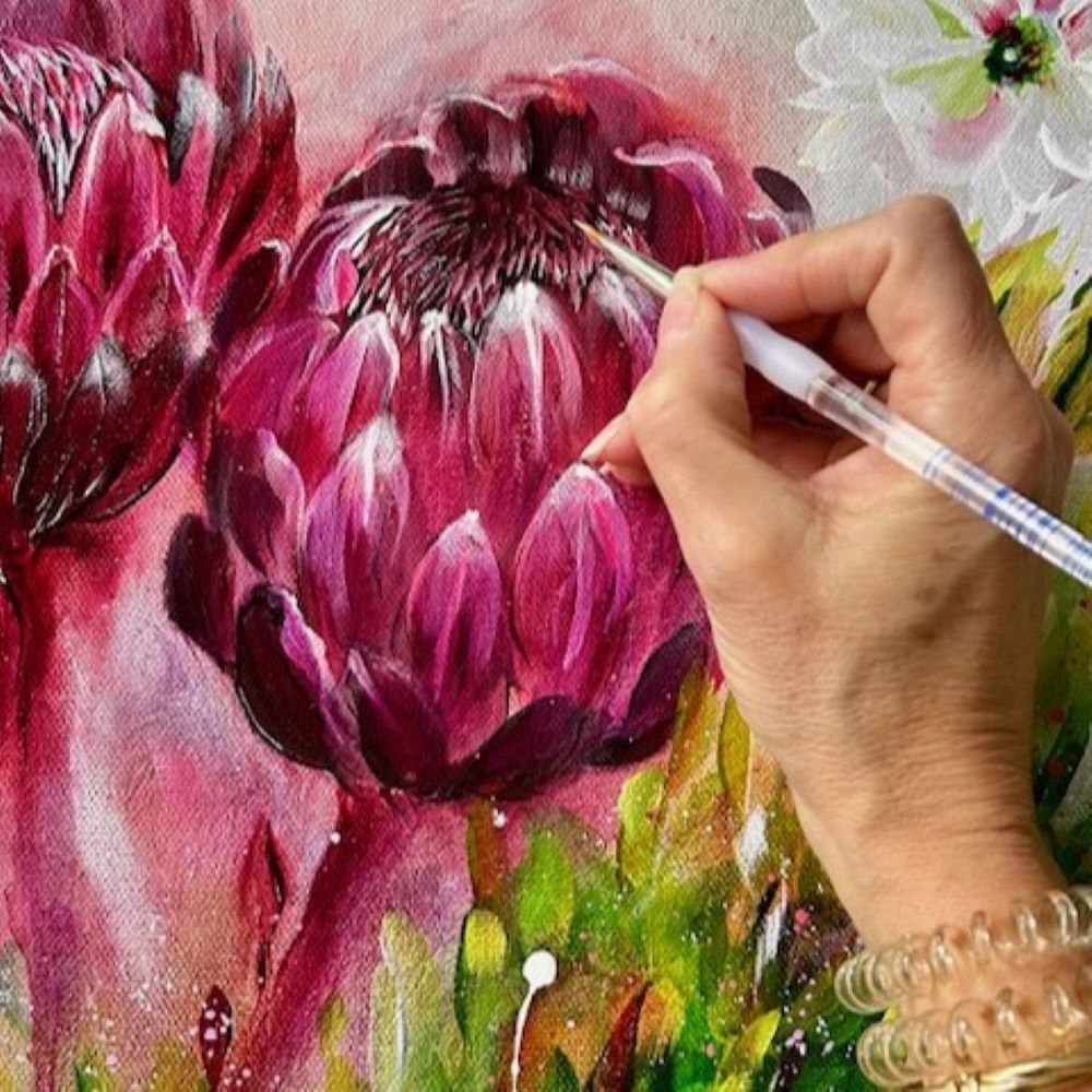 Hand painting a detailed floral Abstract with a focus on pink flowers.