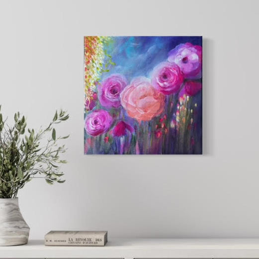 Colorful floral painting on a wall above a white cabinet with a plant and books.